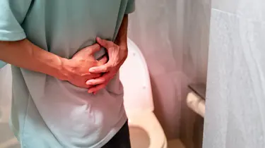 a man having stomach pain linked to constipation symptoms